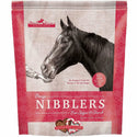 A horse standing behind a bag of Omega Fields Nibblers Peppermint Treats